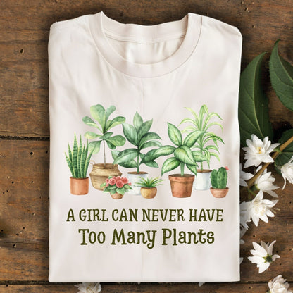Natural S-size tee with "A Girl Can Never Have Too Many Plants" text and watercolor houseplant art.
