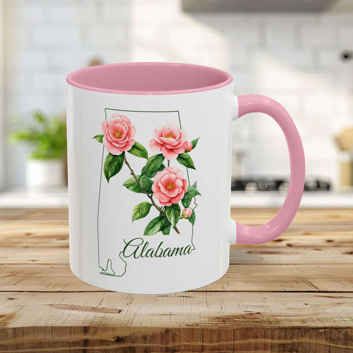 11oz glossy white ceramic mug with pink interior/handle, featuring Alabama state outline and pink camellia flowers.