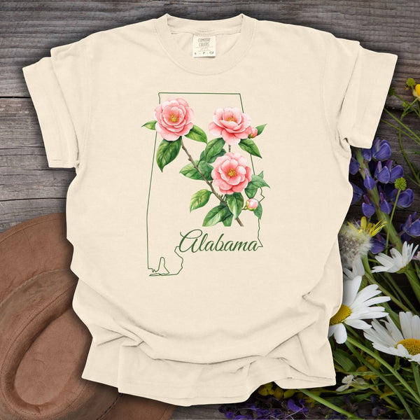 Ivory S t-shirt with a green Alabama outline and pink camellia flowers.
