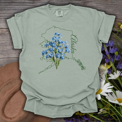 Bay green cotton t-shirt with Alaska outline and blue forget-me-not flowers.
