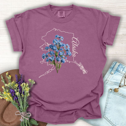 Berry S-size cotton tee with an outline of Alaska and blue forget-me-not flowers.