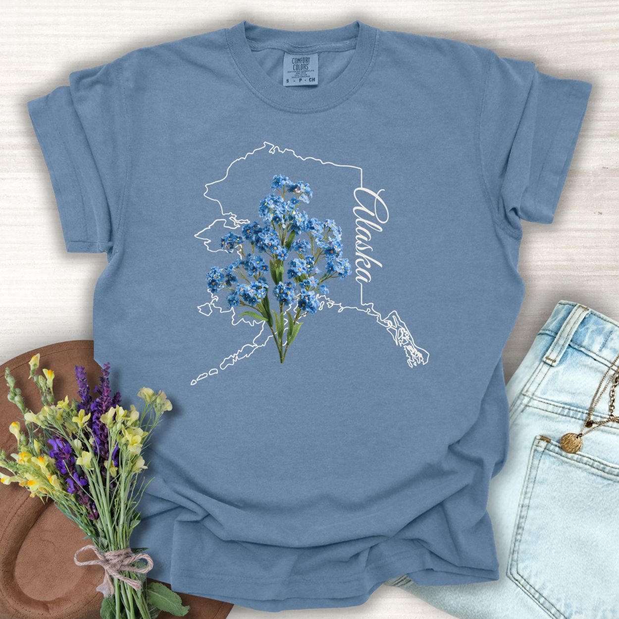 Blue Jean S t-shirt with Alaska outline and Alpine Forget-Me-Not flowers.
