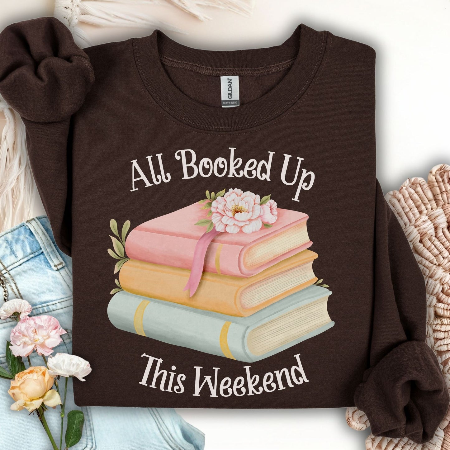 Dark chocolate crewneck sweatshirt with "All Booked Up This Weekend" and watercolor stack of books.