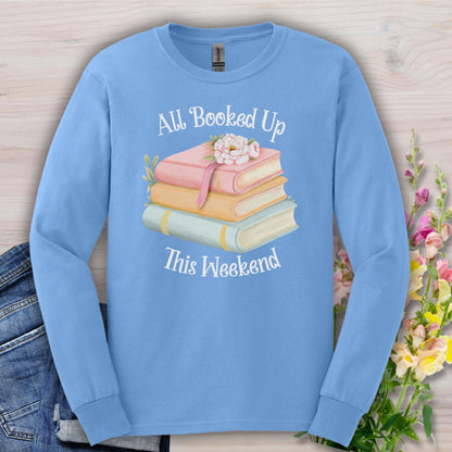 Carolina Blue long sleeve tee with "All Booked Up This Weekend" text, pastel books, and flowers.