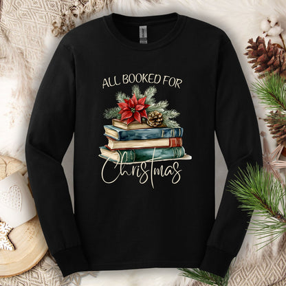 Black long sleeve tee with vintage watercolor stack of books, poinsettia, and "All Booked for Christmas" text.