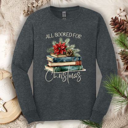 Dark Heather long sleeve tee with vintage watercolor stack of books, poinsettia, and "All Booked for Christmas" text.