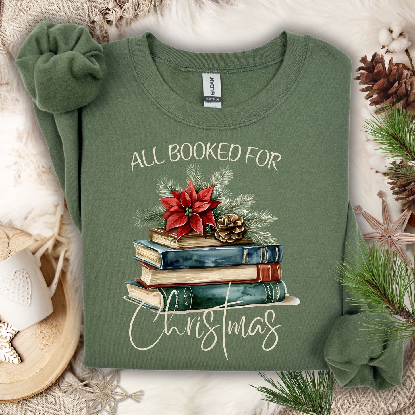 Military Green "All Booked for Christmas" sweatshirt with vintage watercolor books, poinsettia, and evergreen.