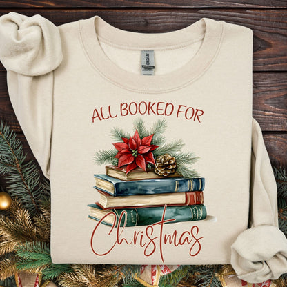 Sand "All Booked for Christmas" sweatshirt with vintage watercolor books, poinsettia, and evergreen design.
