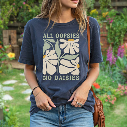 Garment-dyed navy blue "All Oopsies No Daisies" retro floral t-shirt on a woman in a garden.