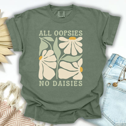 Moss green garment-dyed cotton t-shirt with "All Oopsies No Daisies" text and retro floral design.