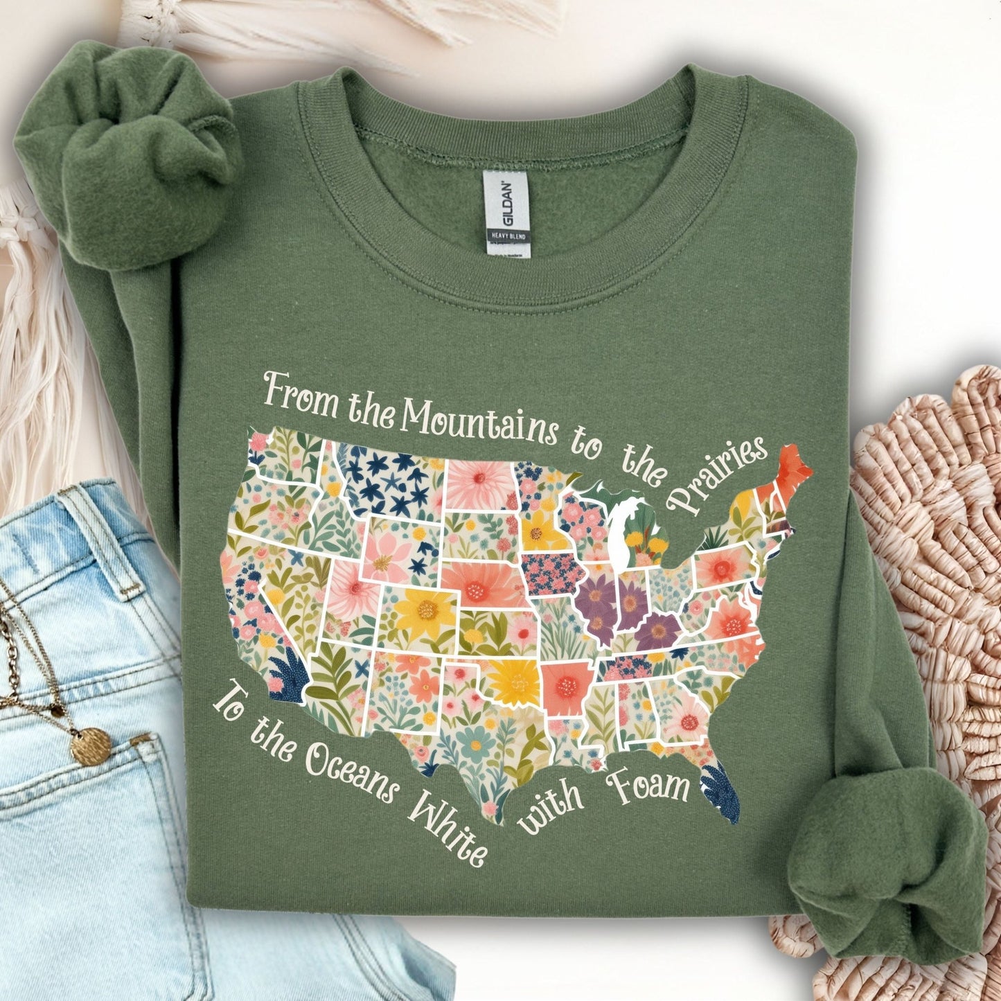 Military green crewneck sweatshirt with a floral watercolor US map and "From the Mountains to the Prairies" text.