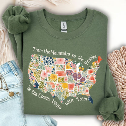 Military green crewneck sweatshirt with a floral watercolor US map and "From the Mountains to the Prairies" text.