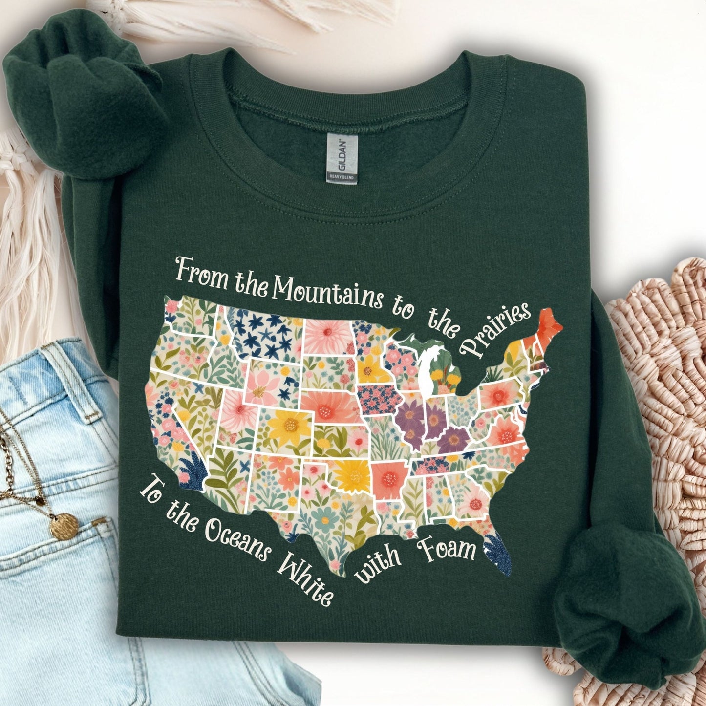 Forest Green crewneck sweatshirt with a watercolor floral map of the USA and "From the Mountains to the Prairies" text.