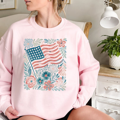Pink crewneck sweatshirt with a watercolor American flag and floral design.