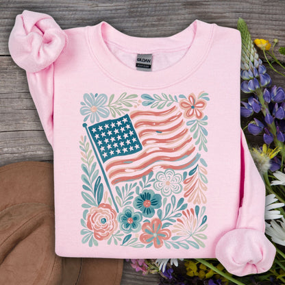 Light pink Gildan sweatshirt with a watercolor American flag and floral design.