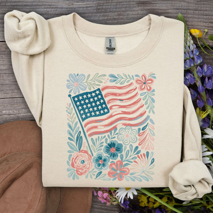 Sand American Flag & Flowers sweatshirt, a cozy crewneck with a watercolor patriotic floral design.