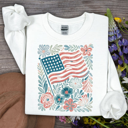 White Gildan sweatshirt with watercolor American flag and floral design.
