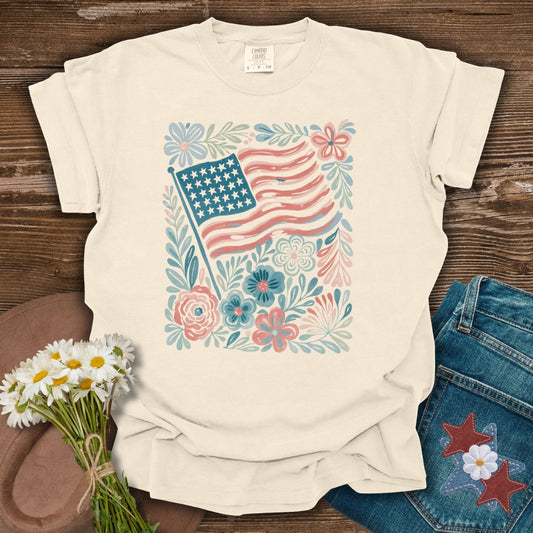 Ivory relaxed-fit cotton t-shirt with a vintage American flag and floral illustration.