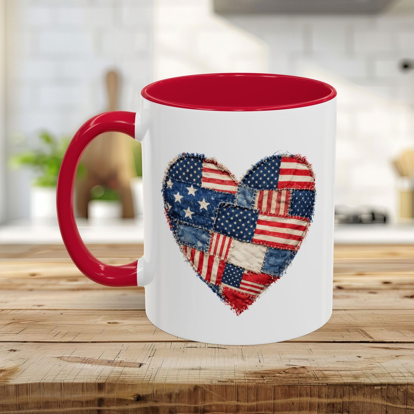 White ceramic mug with a red interior and handle, featuring a stitched American flag patchwork heart design.