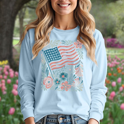 Light blue long sleeve tee with a vintage American flag and hand-drawn floral design, worn by a smiling woman.