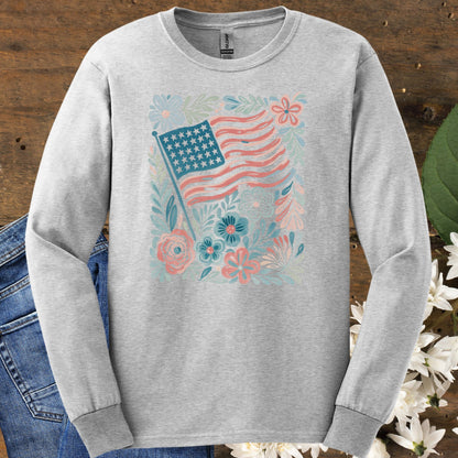 Ash long sleeve tee with a vintage-style American flag and hand-drawn flowers in muted red, blue, and green.