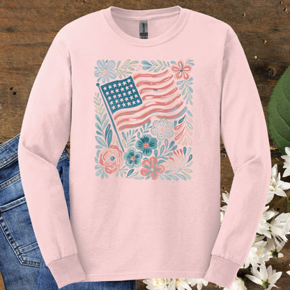Light pink long sleeve tee with a vintage American flag and hand-drawn floral design, made from soft USA-grown cotton.