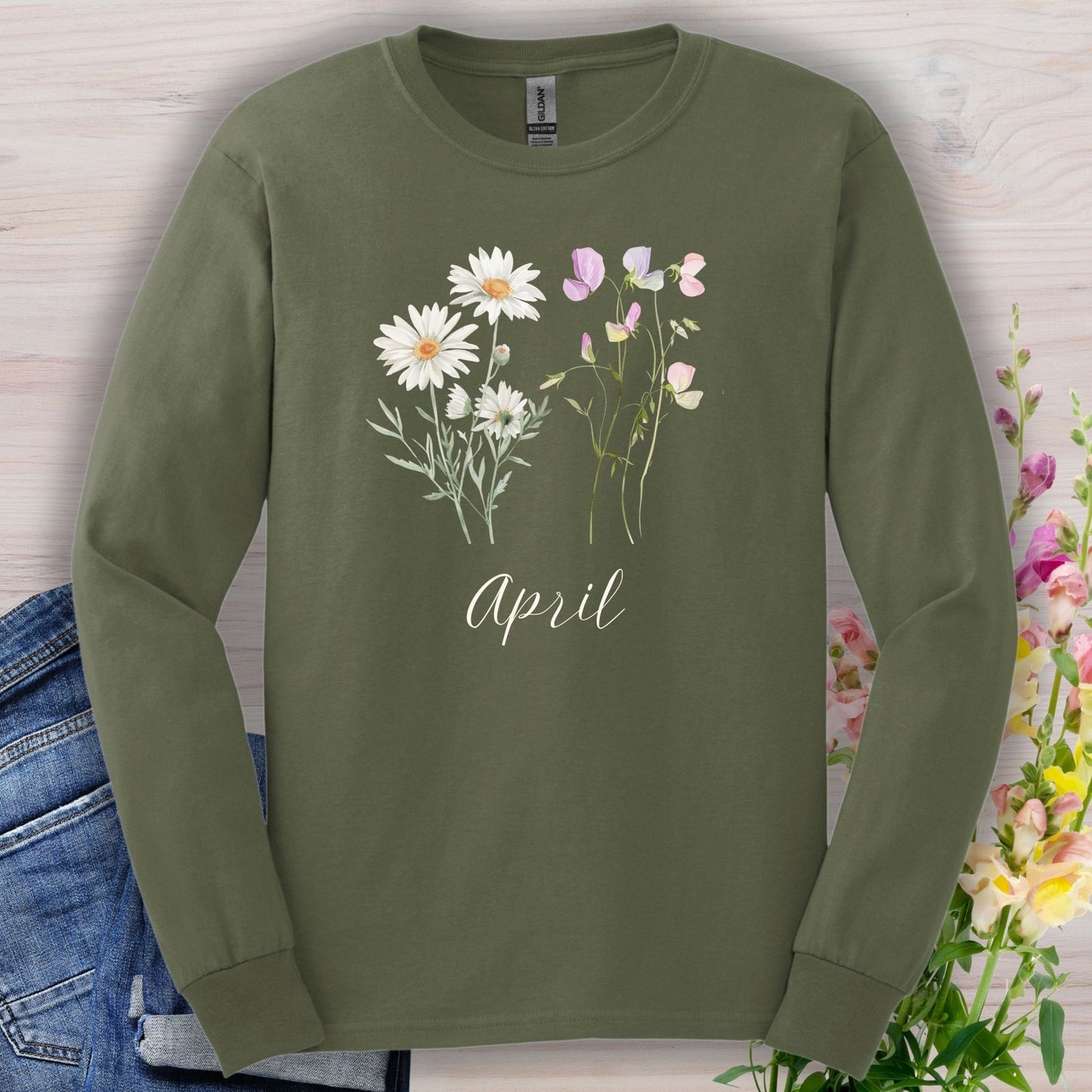 Olive green long sleeve tee with hand-drawn daisies, sweet peas, and "April" script.