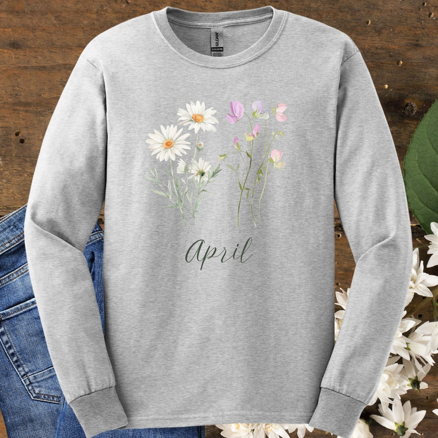 Ash gray long sleeve tee with hand-drawn daisy and sweet pea flowers, "April" script, and ribbed collar.