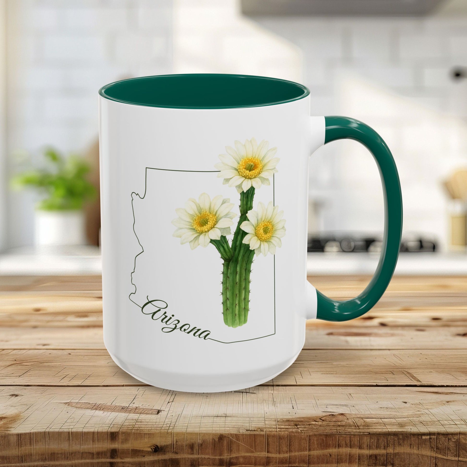 White ceramic 11oz mug with green handle/interior, featuring an Arizona outline and blooming saguaro cactus.