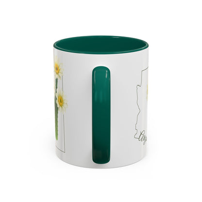White ceramic mug with green handle and interior, featuring an Arizona outline and blooming saguaro cactus.