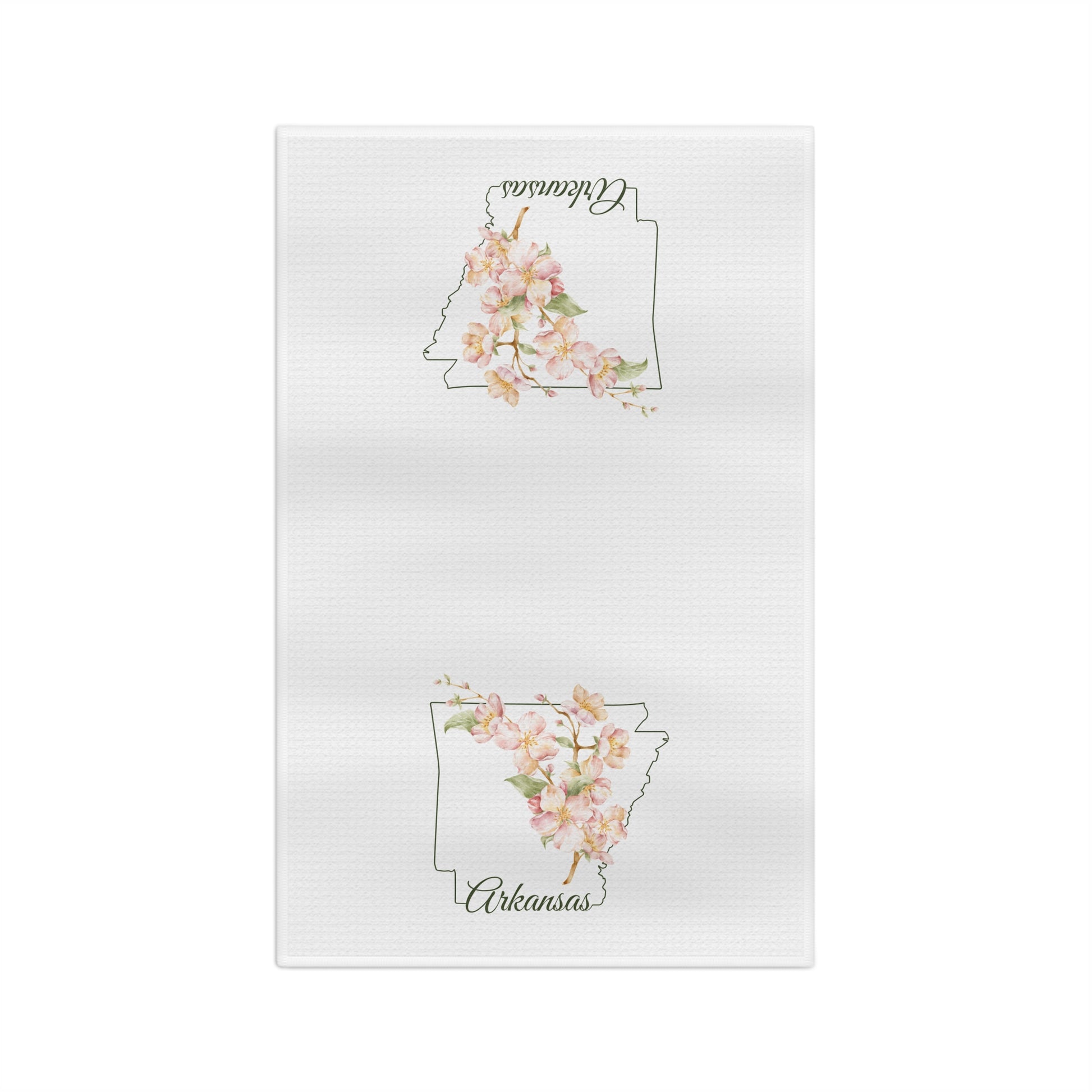 White microfiber tea towel with a delicate Arkansas silhouette layered with watercolor dogwood blossoms.