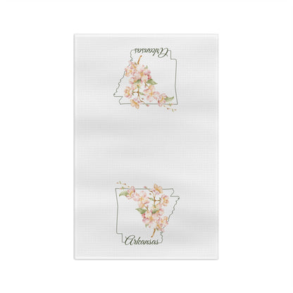 White microfiber tea towel with a delicate Arkansas silhouette layered with watercolor dogwood blossoms.