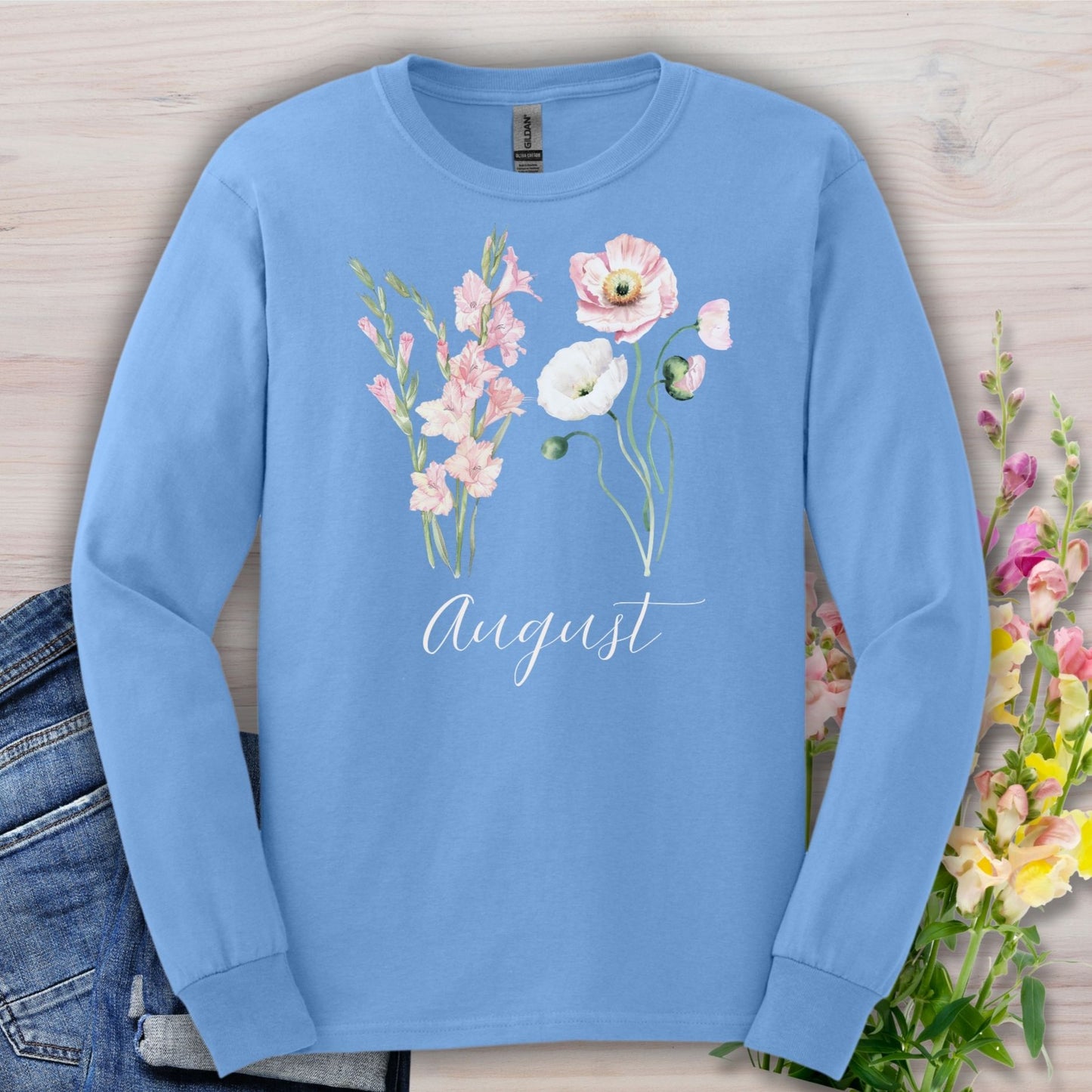 Carolina Blue long-sleeve tee with watercolor gladiolus and poppy flowers, "August" script.