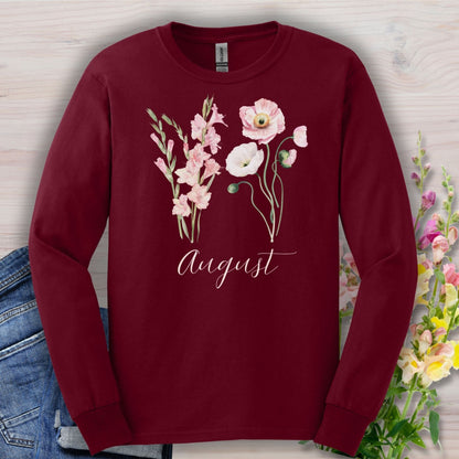 Maroon long-sleeve tee with watercolor gladiolus and poppy flowers, plus "August" script.