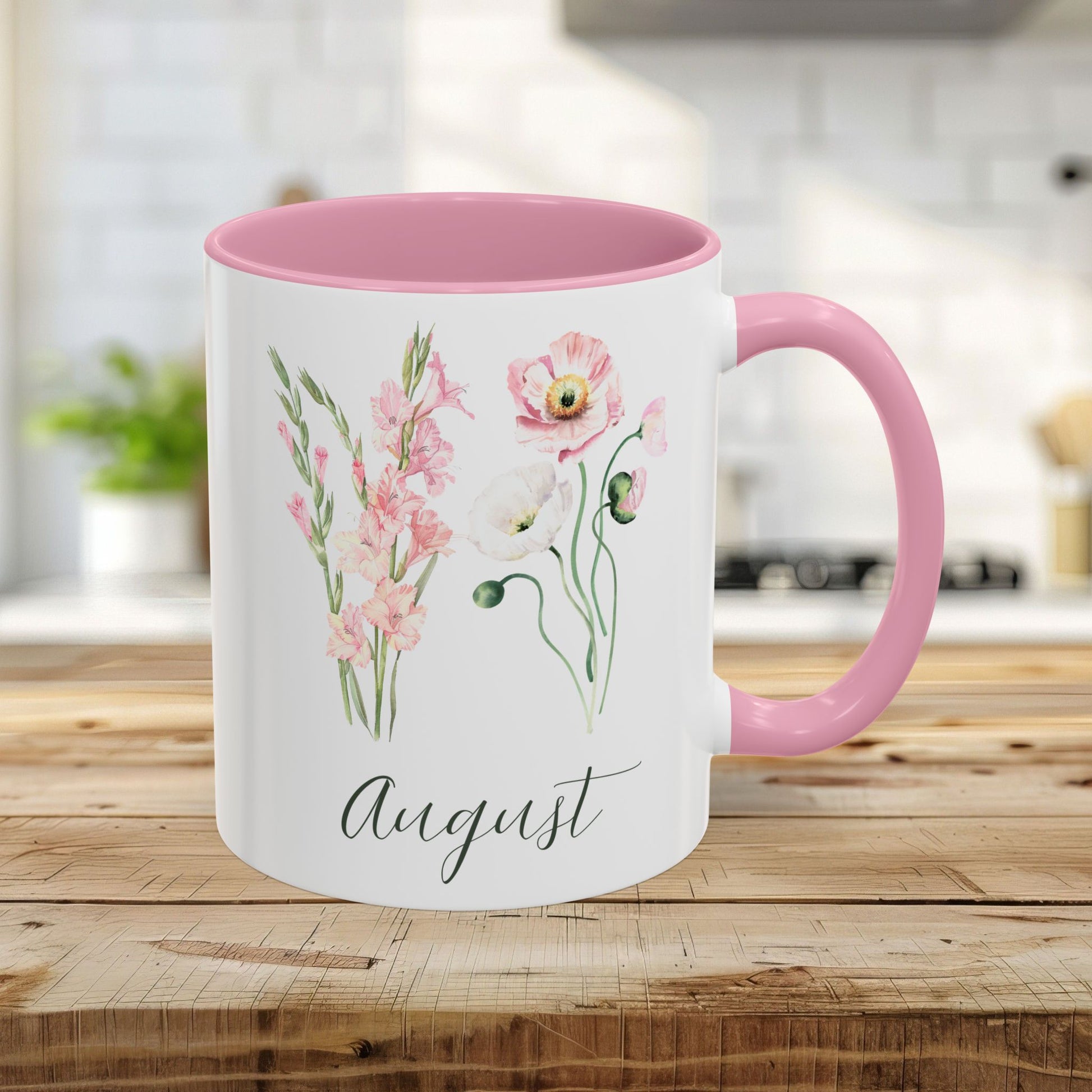 Pink 11oz ceramic mug with watercolor gladiolus, poppy blooms, and "August" script.
