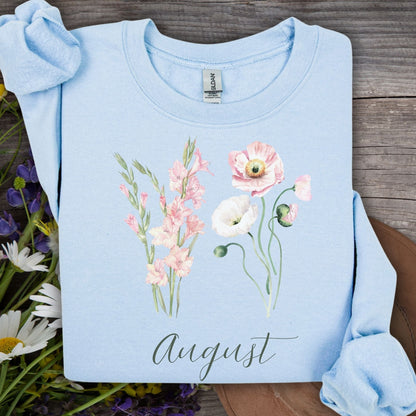 Light blue cotton-poly sweatshirt with watercolor gladiolus and poppy flowers, plus "August" text.