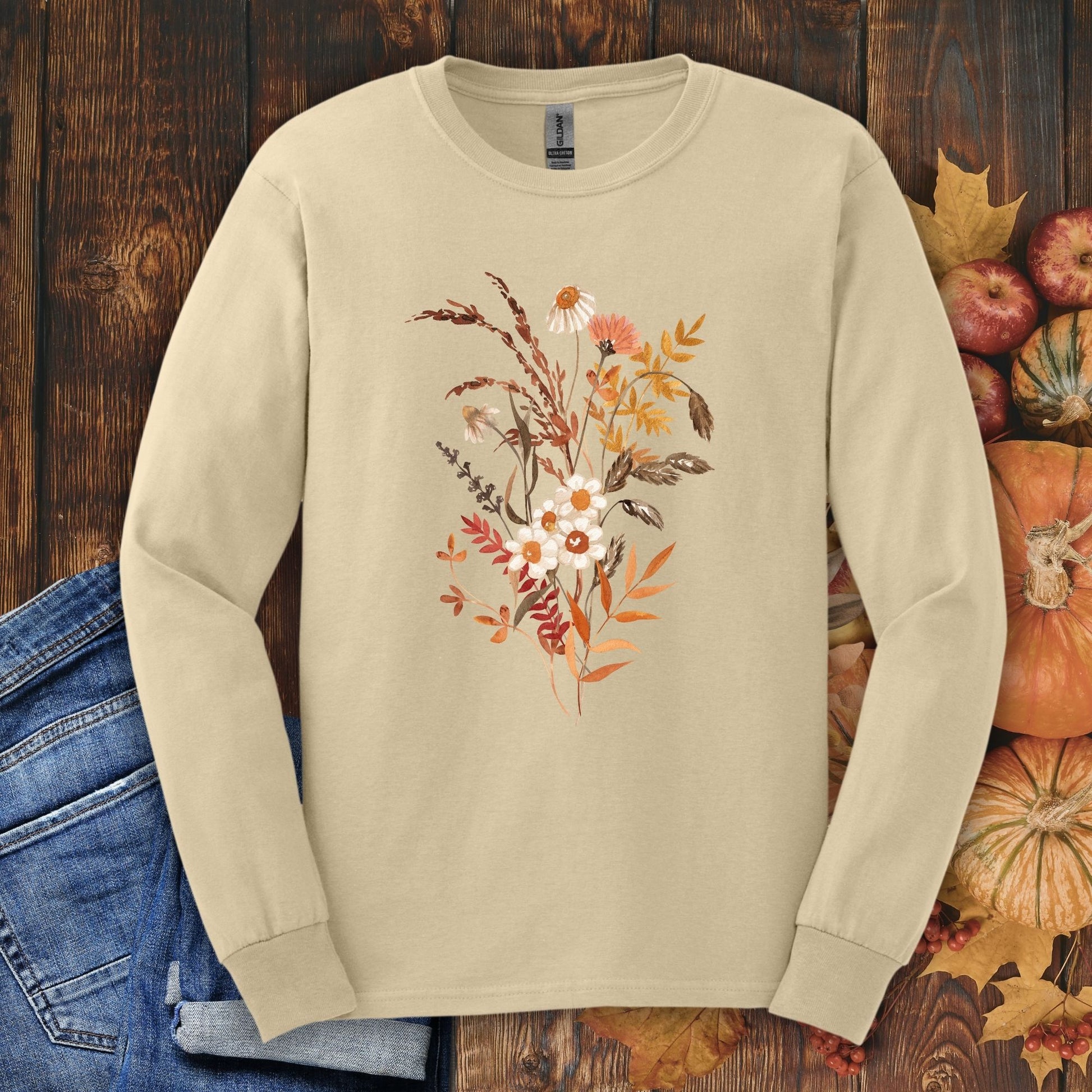Sand Gildan 2400 long sleeve tee with watercolor autumn wildflowers and botanicals, surrounded by fall decor.