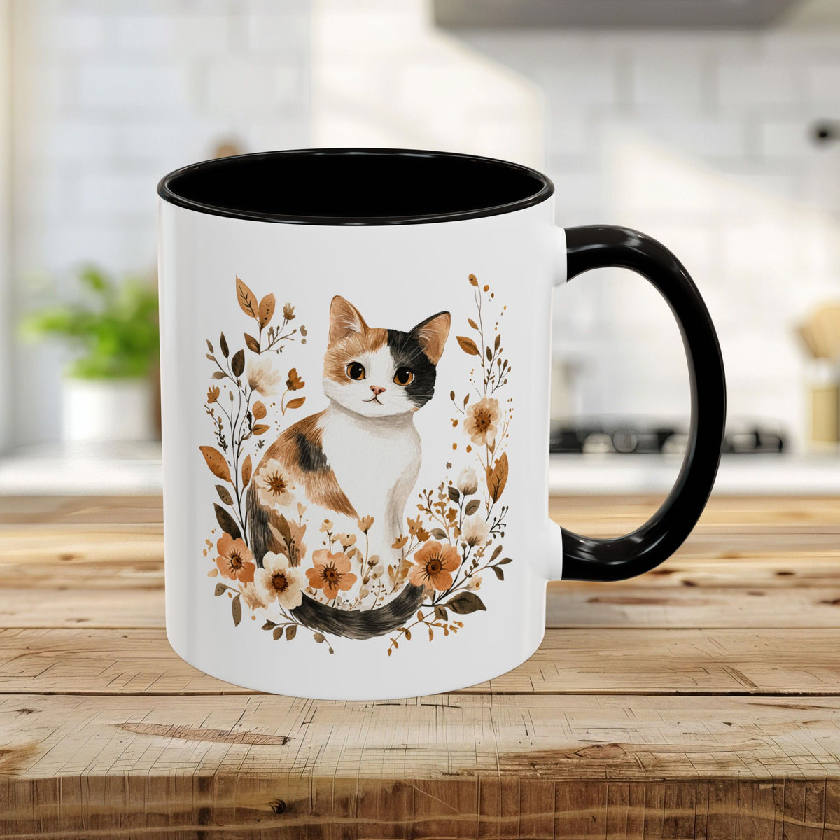 White 11oz ceramic mug with a watercolor calico cat and autumnal florals, black interior and handle.