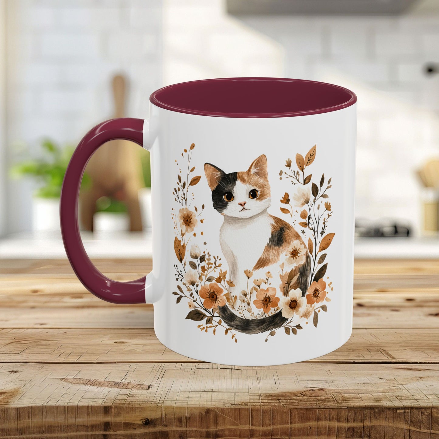 White ceramic mug with a watercolor calico cat and autumnal florals, featuring a black interior and handle.