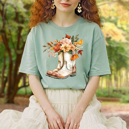 Relaxed-fit, garment-dyed sage green cotton t-shirt with watercolor cowboy boots and autumn flowers.