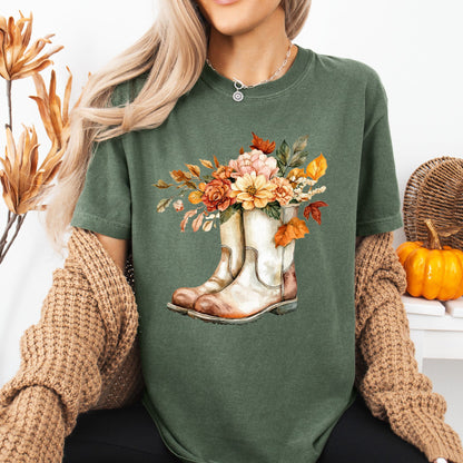 Relaxed-fit, garment-dyed green cotton tee with watercolor cowboy boots and autumn blooms.
