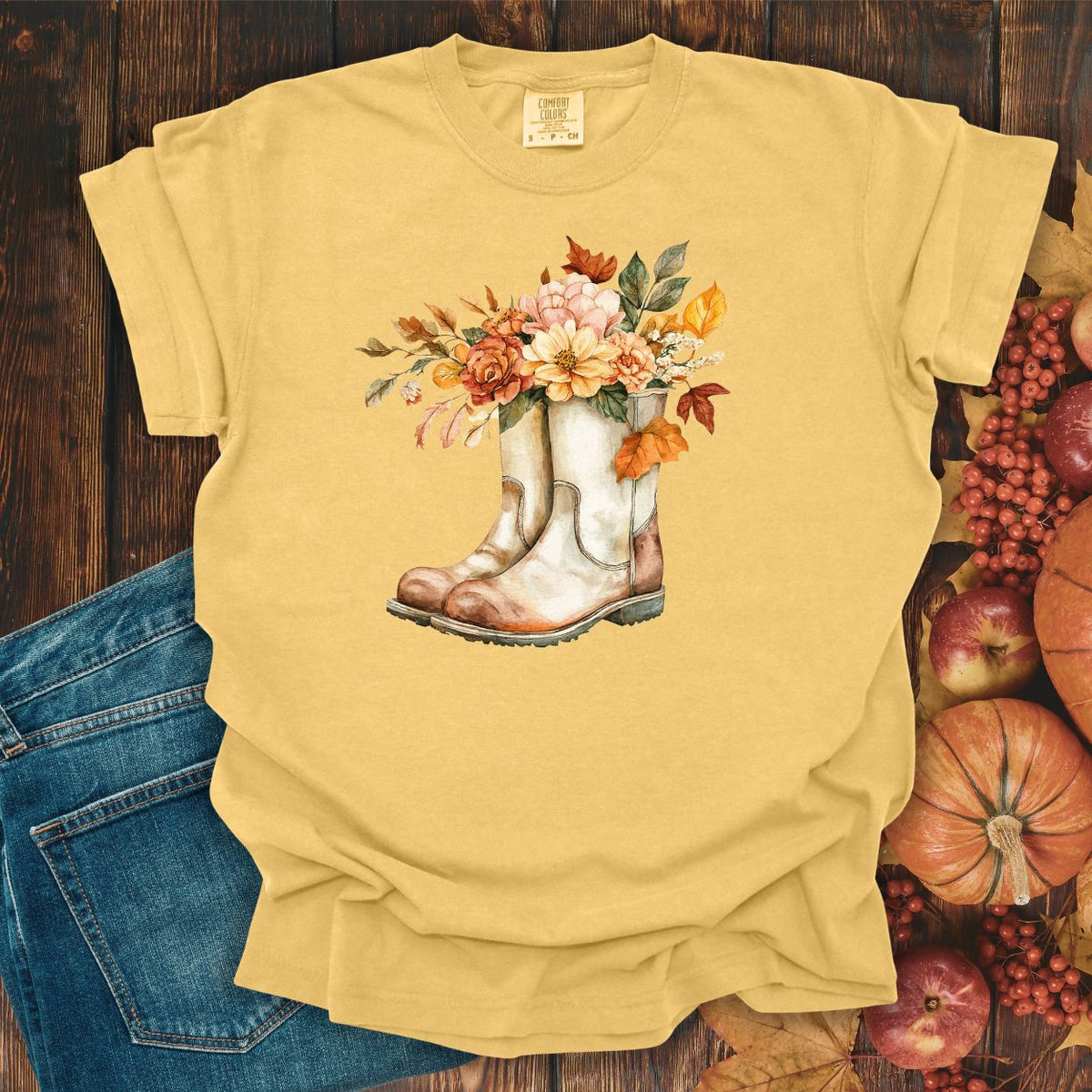 Mustard relaxed-fit cotton tee with watercolor cowboy boots and autumn blooms.