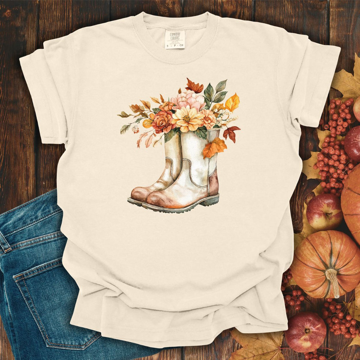 Ivory cotton tee with watercolor cowboy boots overflowing with autumn flowers and leaves.