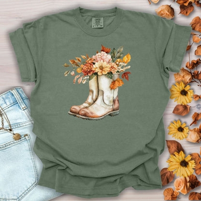 Moss green relaxed-fit cotton tee with watercolor cowboy boots and autumn flowers.