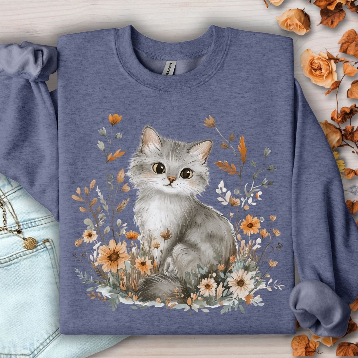 Heather Sport Dark Navy sweatshirt with a grey kitten surrounded by autumn wildflowers.