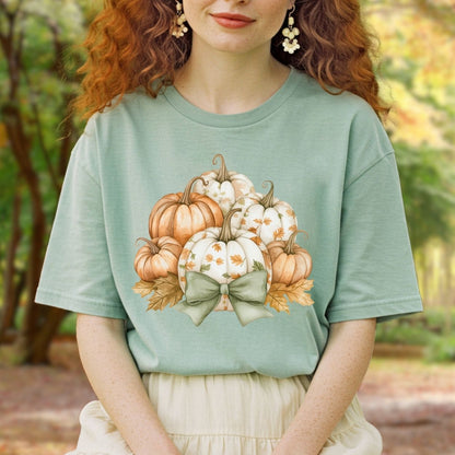 Sage green Comfort Colors tee with watercolor pumpkins, fall leaves, and a sage bow.