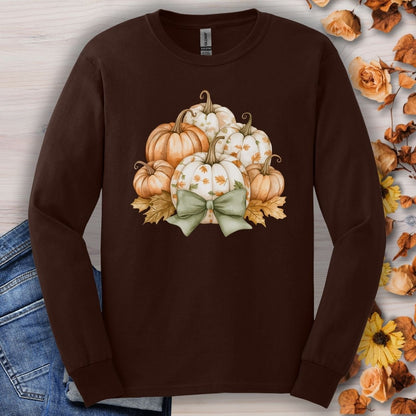 Dark chocolate long-sleeve tee with a watercolor pumpkin and sage bow design, surrounded by autumn leaves.