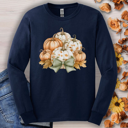 Navy long sleeve tee with a watercolor pumpkin and sage bow design, surrounded by autumn leaves.