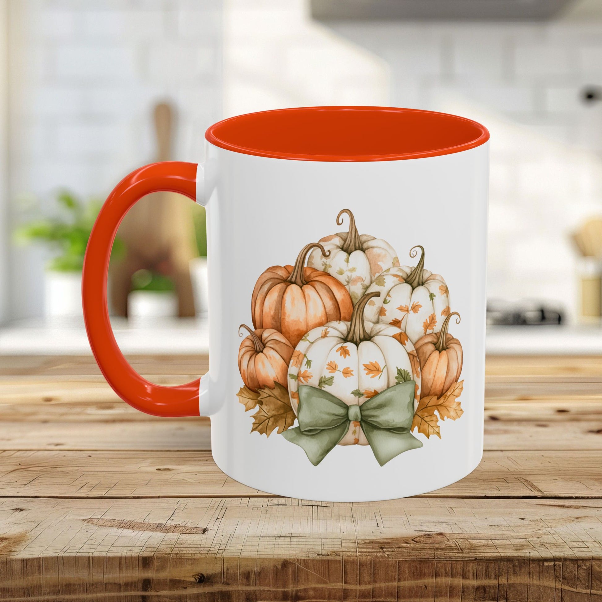 White ceramic mug with orange interior and handle, featuring a watercolor autumn pumpkin bouquet and sage green bow.