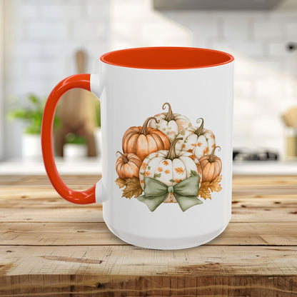 White ceramic mug with orange interior and handle, featuring a watercolor print of pumpkins and fall leaves.